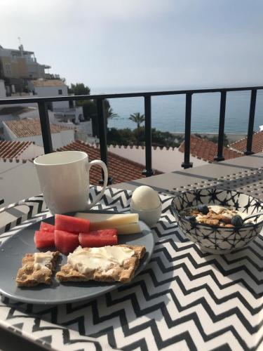 a plate of food on a table on a balcony at Capistrano Playa 307 in Nerja