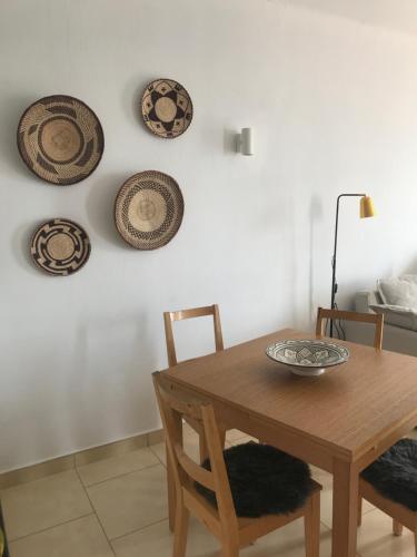 a dining room with a table and plates on the wall at Capistrano Playa 307 in Nerja