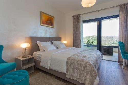 a bedroom with a bed and a large window at View Villas Collection in Vinišće