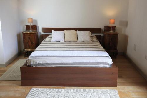 a bedroom with a large bed with two night stands at Bosa Exclusive Apartments "Bosa Apartments" in Bosa