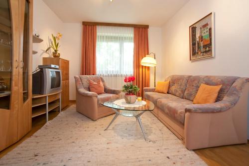 a living room with a couch and a table at Ferienwohnung Zechner in Velden am Wörthersee