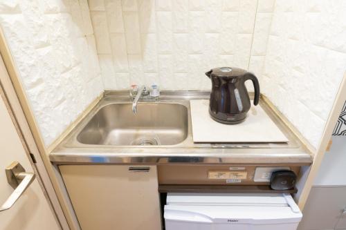 czajnik do herbaty na zlewie kuchennym w obiekcie Dazaifu - Apartment / Vacation STAY 36940 w mieście Dazaifu