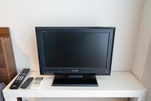 a computer monitor sitting on top of a desk at Dazaifu - Apartment / Vacation STAY 36940 in Dazaifu