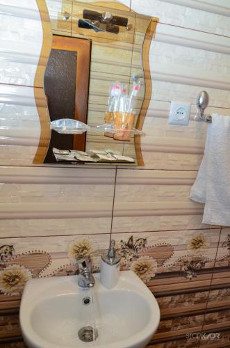 a bathroom with a sink and a mirror at Narek B&B in Goris