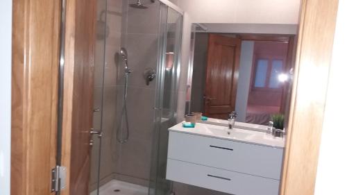 a bathroom with a shower, sink, and tub at Rio NaturAL in Vila Nova de Milfontes