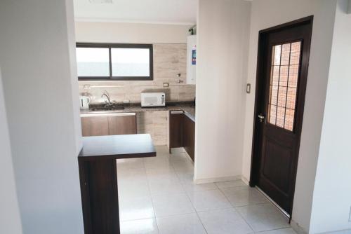 a kitchen with a black door and a sink at Rincon Secreto in San Rafael