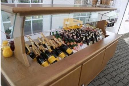 a counter filled with lots of bottles of wine at Landgasthof Haagen in Schwabhausen bei Dachau