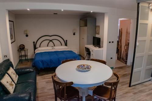 a room with a bed and a table and a couch at Residence Al Lago in Castiglione del Lago