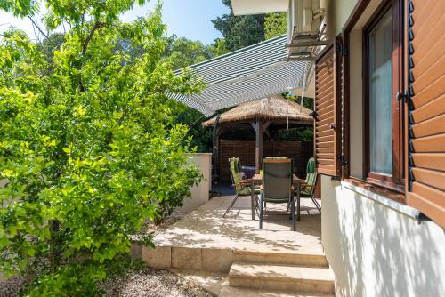 eine Terrasse mit einem Tisch und Stühlen sowie ein Haus in der Unterkunft Zen Luxury Apartments in Zadar