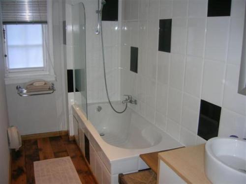 a bathroom with a shower and a tub and a sink at Hotel Kasteelhof 'T Hooghe in Ypres