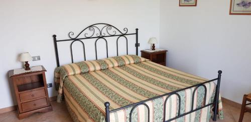 a bedroom with a bed and a wooden nightstand at Stella fiorita in Panicarola