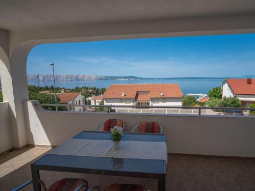 a table on a balcony with a view of the ocean at Apartment Josipa-2 by Interhome in Klenovica