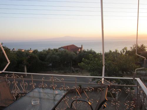 a view of the ocean from the balcony of a house at Blue Yard Apartments in Kalamata