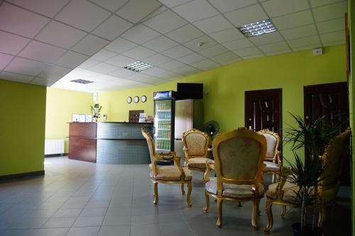a waiting room with chairs and a refrigerator at Hotel Nova in Kyiv
