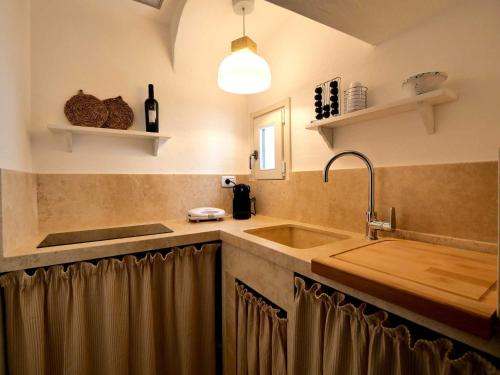 a kitchen with a sink and a counter top at Suite Sirene in Polignano a Mare