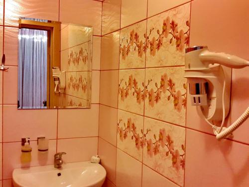 a bathroom with a sink and a mirror at ApartLux Chernigov in Chernihiv