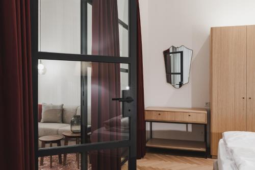 a bedroom with a sliding glass door leading to a living room at Kuntino Suites in Merano