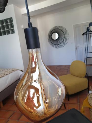 a large glass vase sitting on the floor in a room at Le Clos Marceau in Bédoin