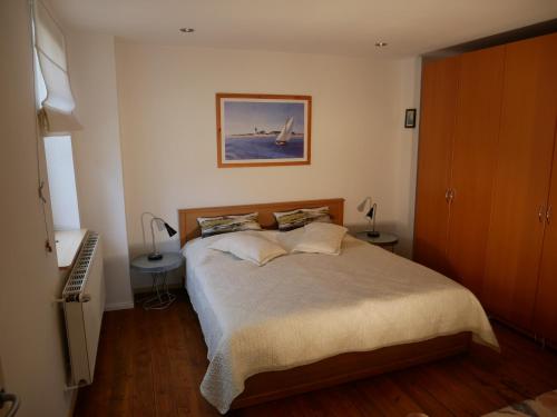 a bedroom with a bed and a picture on the wall at Sonnendeck in Wustrow