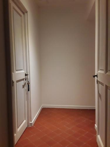 an empty room with an open door and a red tile floor at Le Clos Marceau in Bédoin