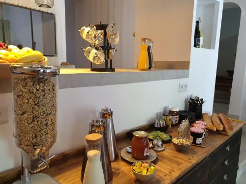 a kitchen counter with food on a wooden table at Le Clos Marceau in Bédoin