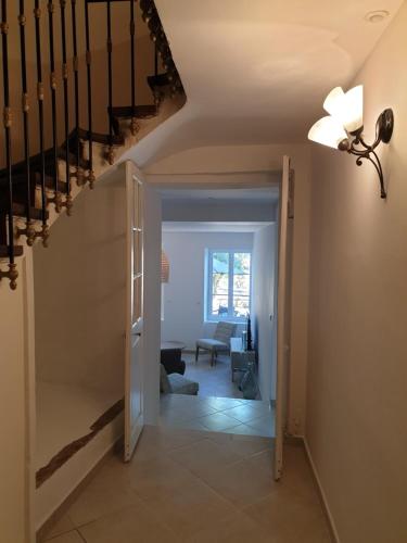 a hallway with a staircase leading to a living room at Le Clos Marceau in Bédoin