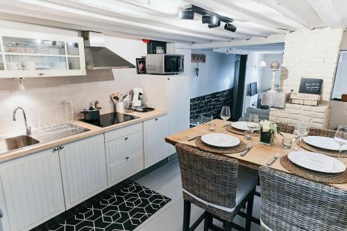 a kitchen with a table with chairs and a counter top at Le Petit Gretedar in Malmedy