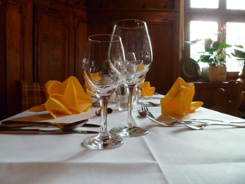 two wine glasses sitting on a table with napkins at Gasthaus Zum Specht in Hösbach