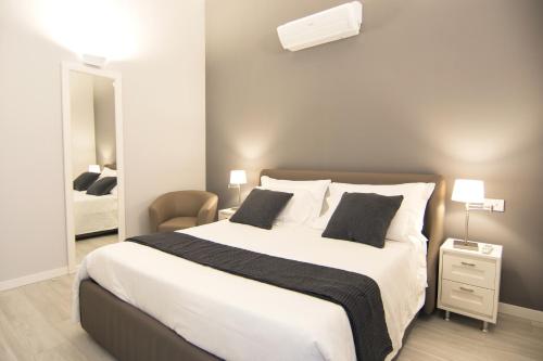 a bedroom with a large bed with two pillows at LA QUADRA SUITES - Central Apartments in Iseo with daily housekeeping in Iseo