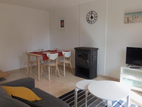 a living room with a table and a dining room at longère de kervéguen ARGOAT in Leuhan