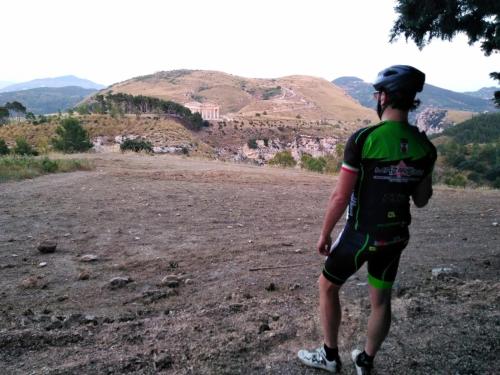 a man standing on a dirt field with a mountain at La Dimora Di Segesta B&B in Calatafimi