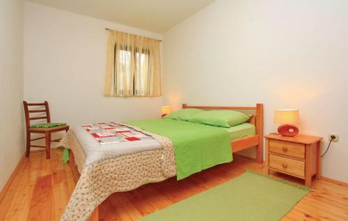 a bedroom with a green bed and a chair at Trstenik, Karla in Trstenik