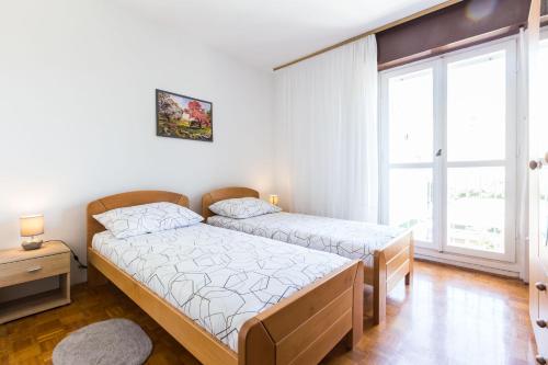 Postel nebo postele na pokoji v ubytování Nina Apartment