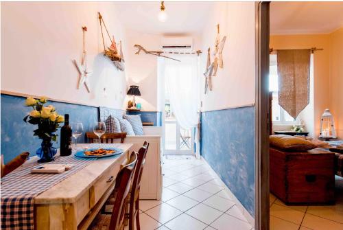 a kitchen with a table and a blue wall at Casetta del borghetto -Nel cuore del Borghetto in Nettuno