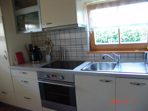 a kitchen with a sink and a stove at Apartments Lana in Bled