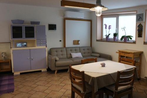 a living room with a couch and a table at IL LILLA in Ankaran