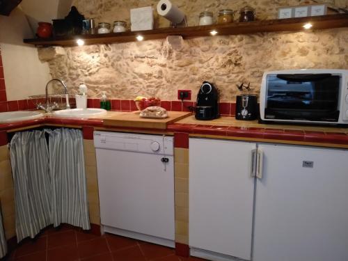 cocina con armarios blancos y microondas en Ca' de Pria, en Borgio Verezzi