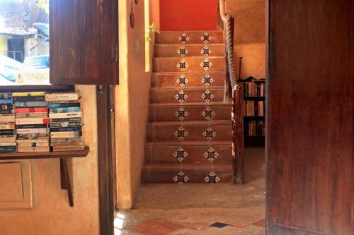a set of stairs in a room with books at Hotel Barrio Latino in Playa del Carmen