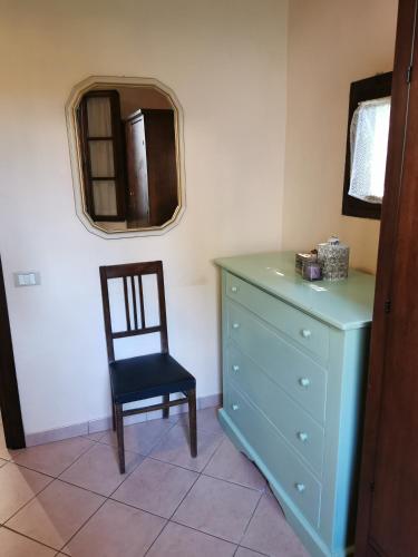 a blue dresser and a chair in a room at Agriturismo Pettinari in Marina di Grosseto