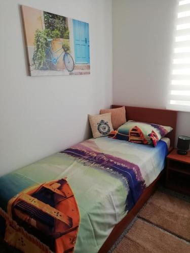 a bedroom with a bed and a picture on the wall at Apartment Sun & Sea in Krk