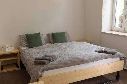 a bedroom with a large bed with green pillows at Natura in Trenčianske Teplice