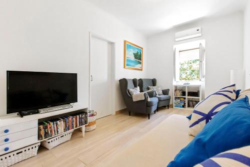 a living room with a large flat screen tv at MantaGarden in Manta Rota