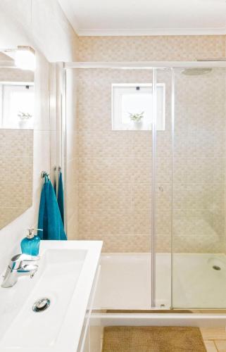 a bathroom with a shower and a sink at MantaGarden in Manta Rota