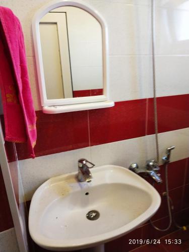 a white sink in a bathroom with a mirror at Caspian Star in Sumqayyt