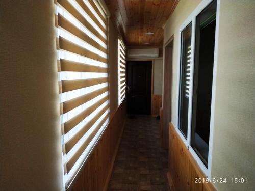 a hallway with wood paneled walls and windows at Caspian Star in Sumqayyt
