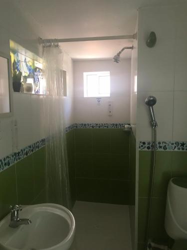 a bathroom with a sink and a shower at San Andres Ultd Inn RNT # 30017 in San Andrés