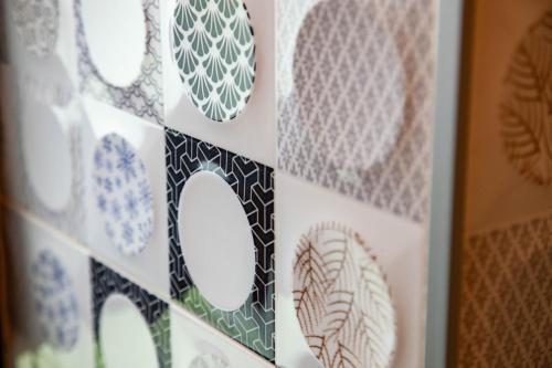 a collage of drawings of plates on a wall at 123 Hall in Wujie
