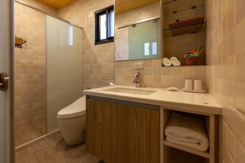 a bathroom with a sink and a toilet at 123 Hall in Wujie