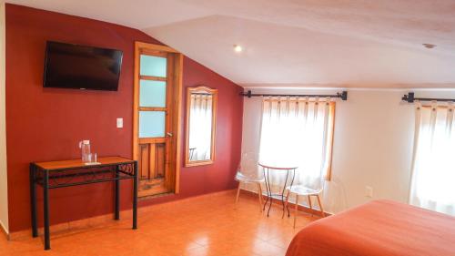 TV a/nebo společenská místnost v ubytování Hotel Casa Margarita
