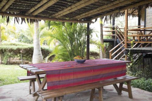 a wooden picnic table with a bowl on top of it at Coco Ne in Máncora